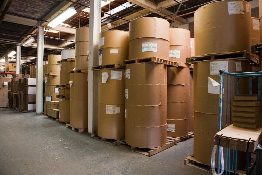 A warehouse filled with lots of cardboard rolls.
