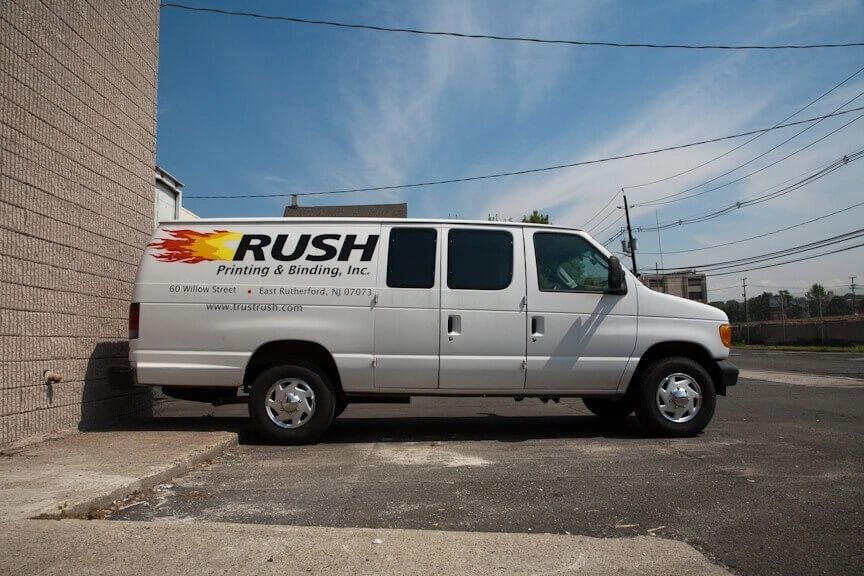 A white truck with the word rush written on it.