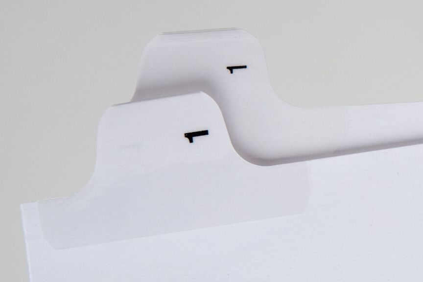 A close up of the top of two white paper holders.