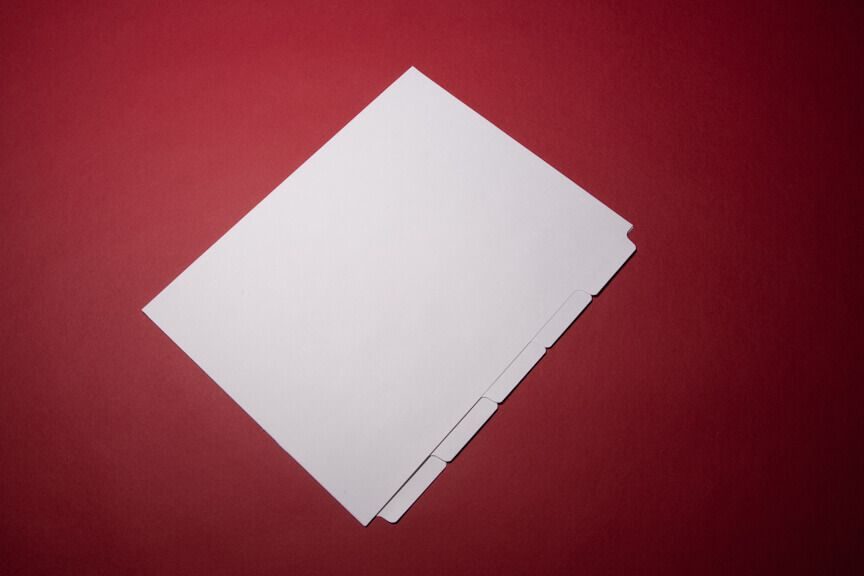 A piece of paper on top of a red table.